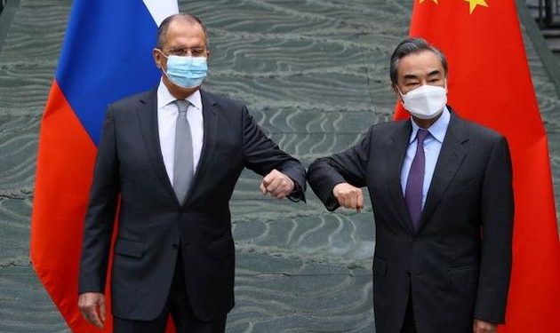 Rejecting criticism, Chinese and Russians meet in show of unity