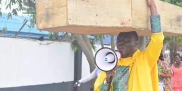 ‘God not happy with Buhari govt’ – Nigerian pastor carries coffin in protest