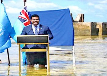 Standing in rising waters, Tuvalu Foreign Minister speaks at COP26