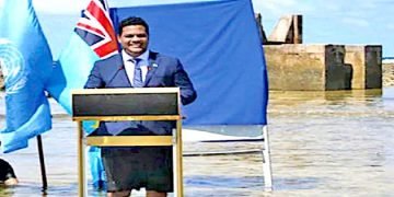 Standing in rising waters, Tuvalu Foreign Minister speaks at COP26
