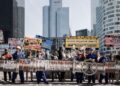 Pro-climate activists protest French government’s support for TotalEnergies, demand end to funding of fossil fuel expansion